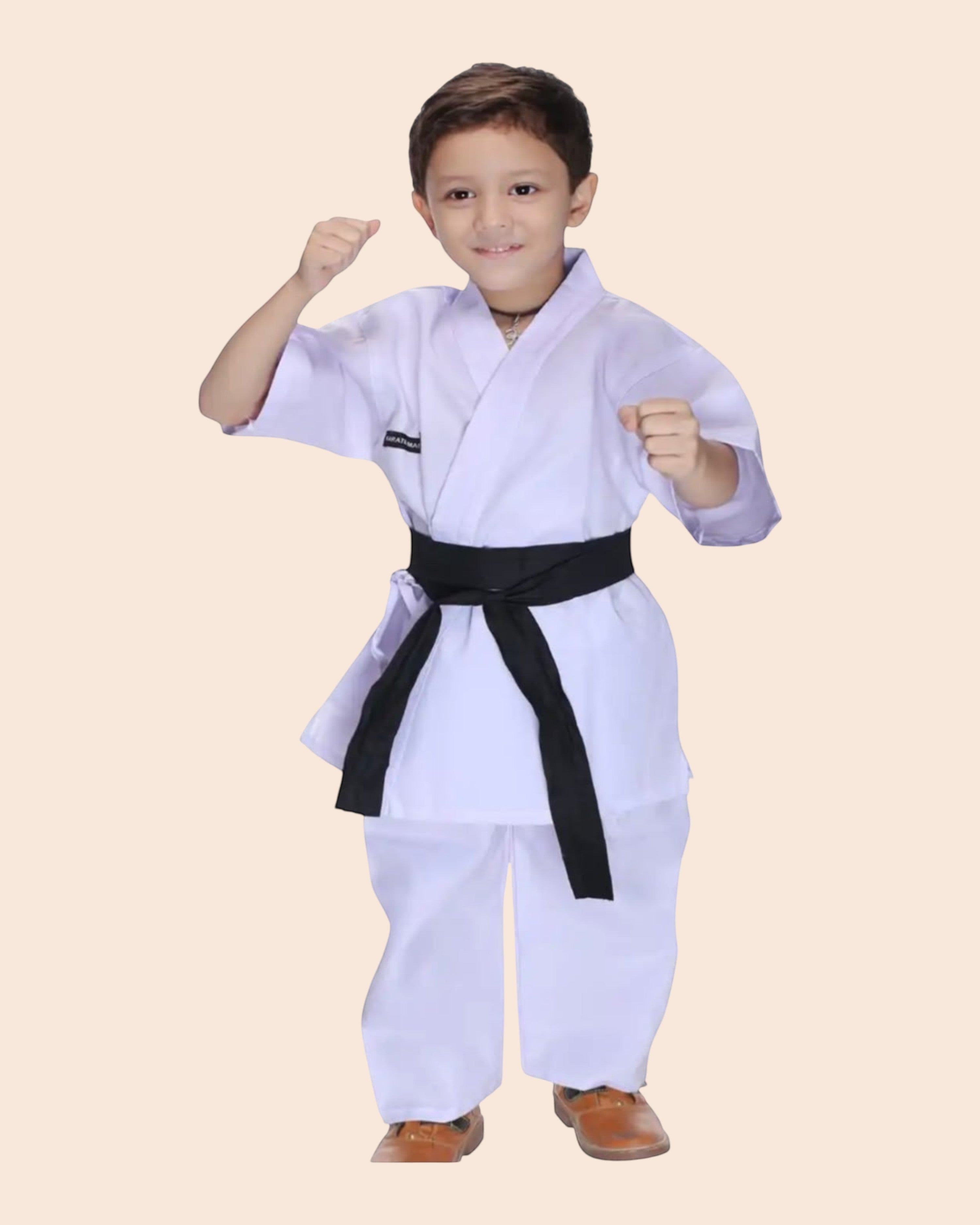 Shop kids karate fancy dress costume with black belt. White martial arts uniform for boys and girls, ideal for school events and stage performances.