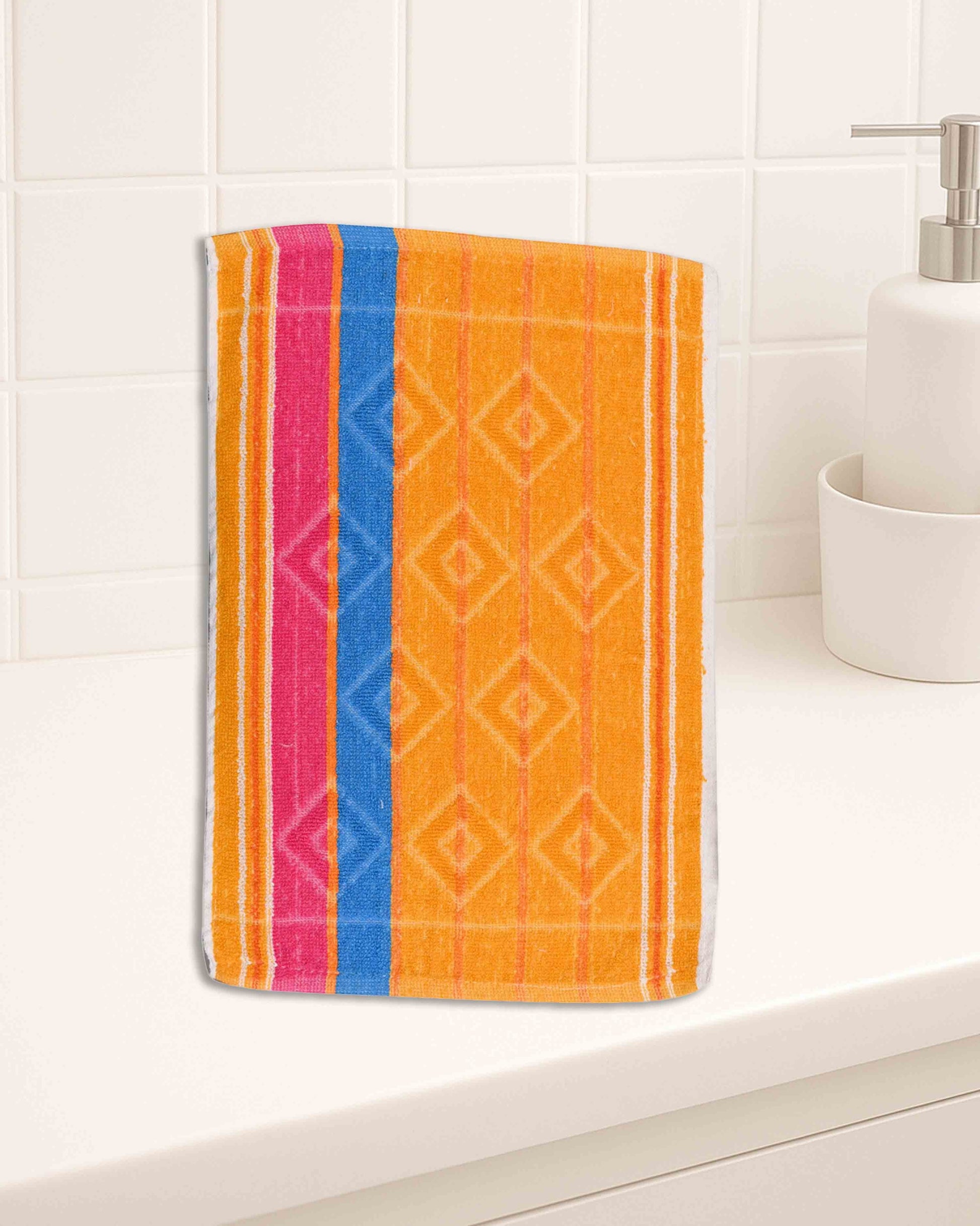 Ambika Stores multicolor striped cotton hand towel with geometric diamond pattern on a white bathroom counter