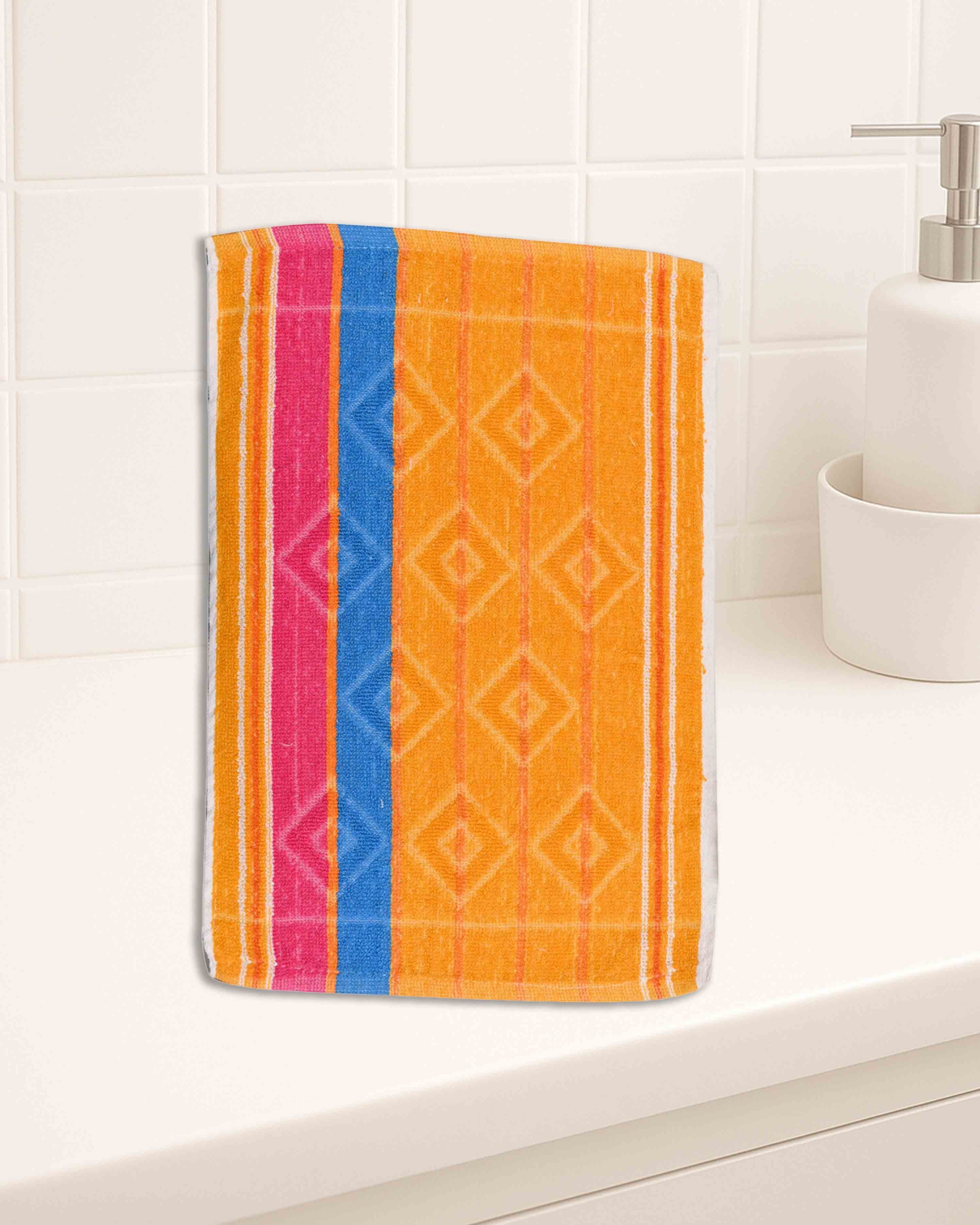 Ambika Stores multicolor striped cotton hand towel with geometric diamond pattern on a white bathroom counter