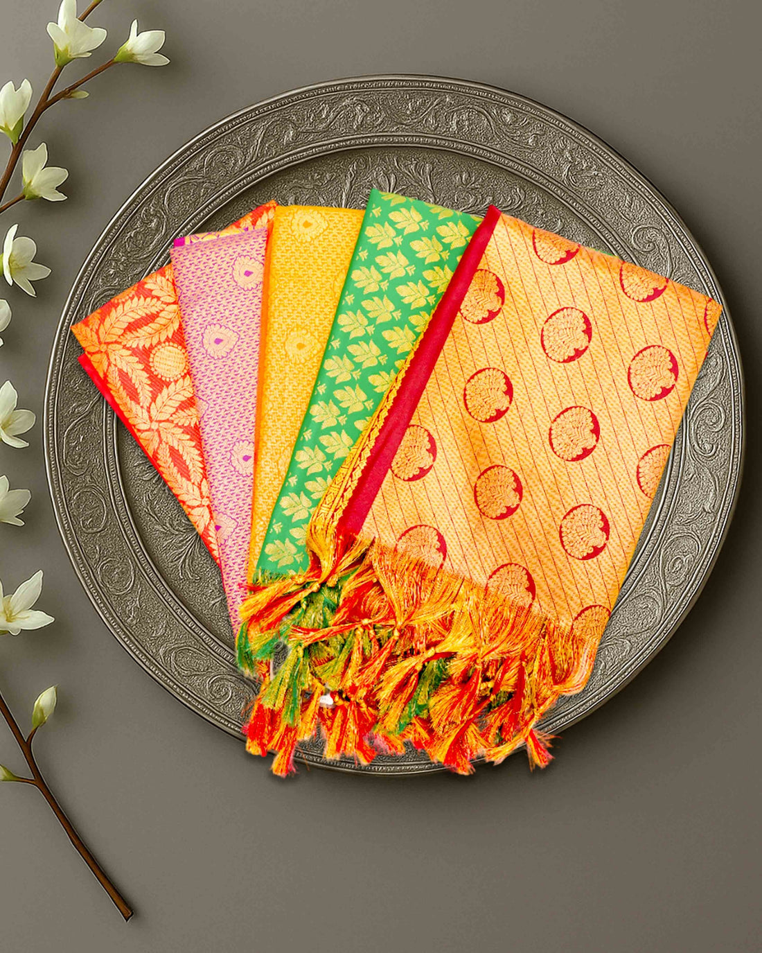 Ambika Stores premium Ponnadai Jari shawls in vibrant colours with intricate gold patterns and decorative tassels.