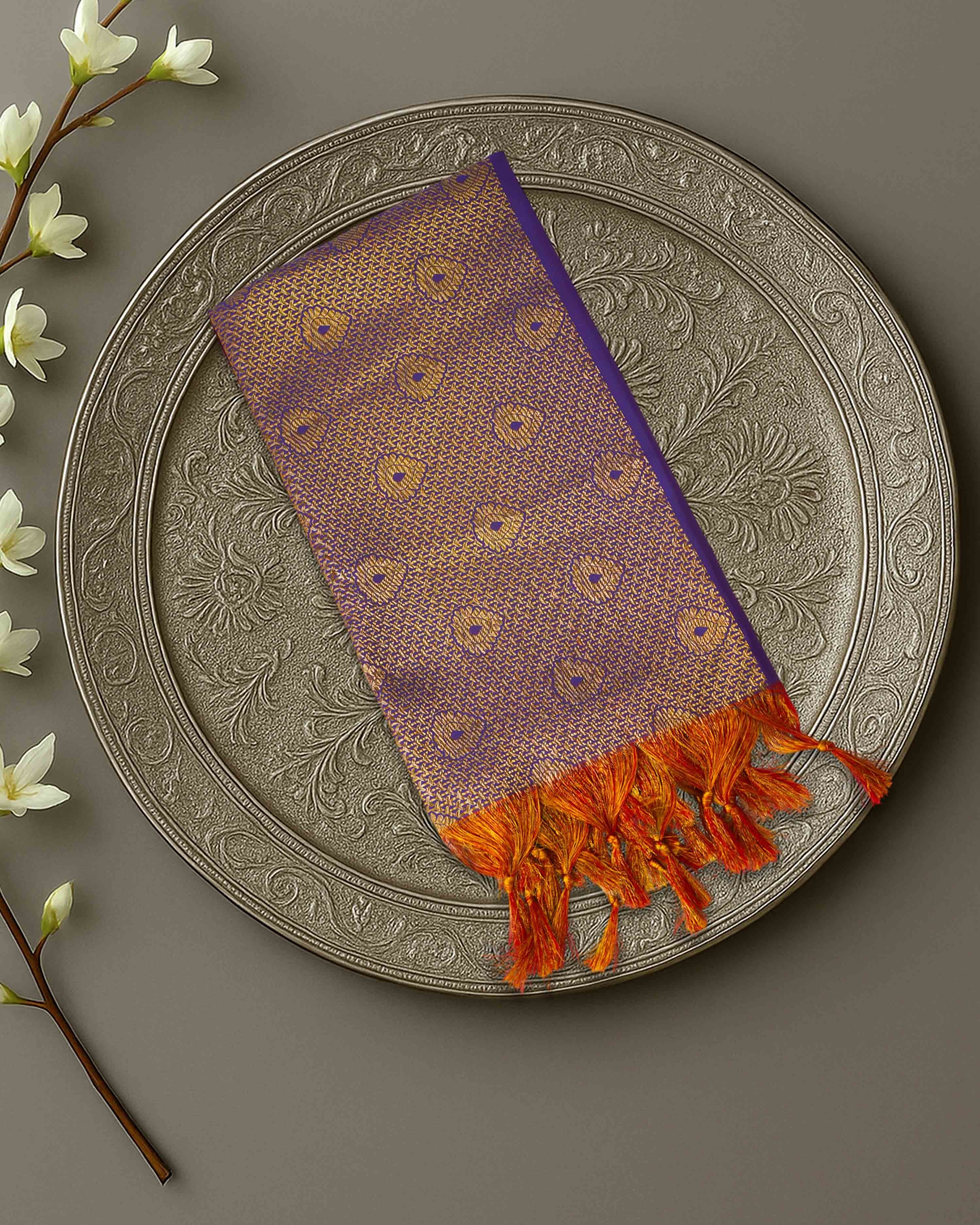 Ambika Stores purple and gold zari Ponnadai shawl with orange tassels, displayed on an ornate silver plate.