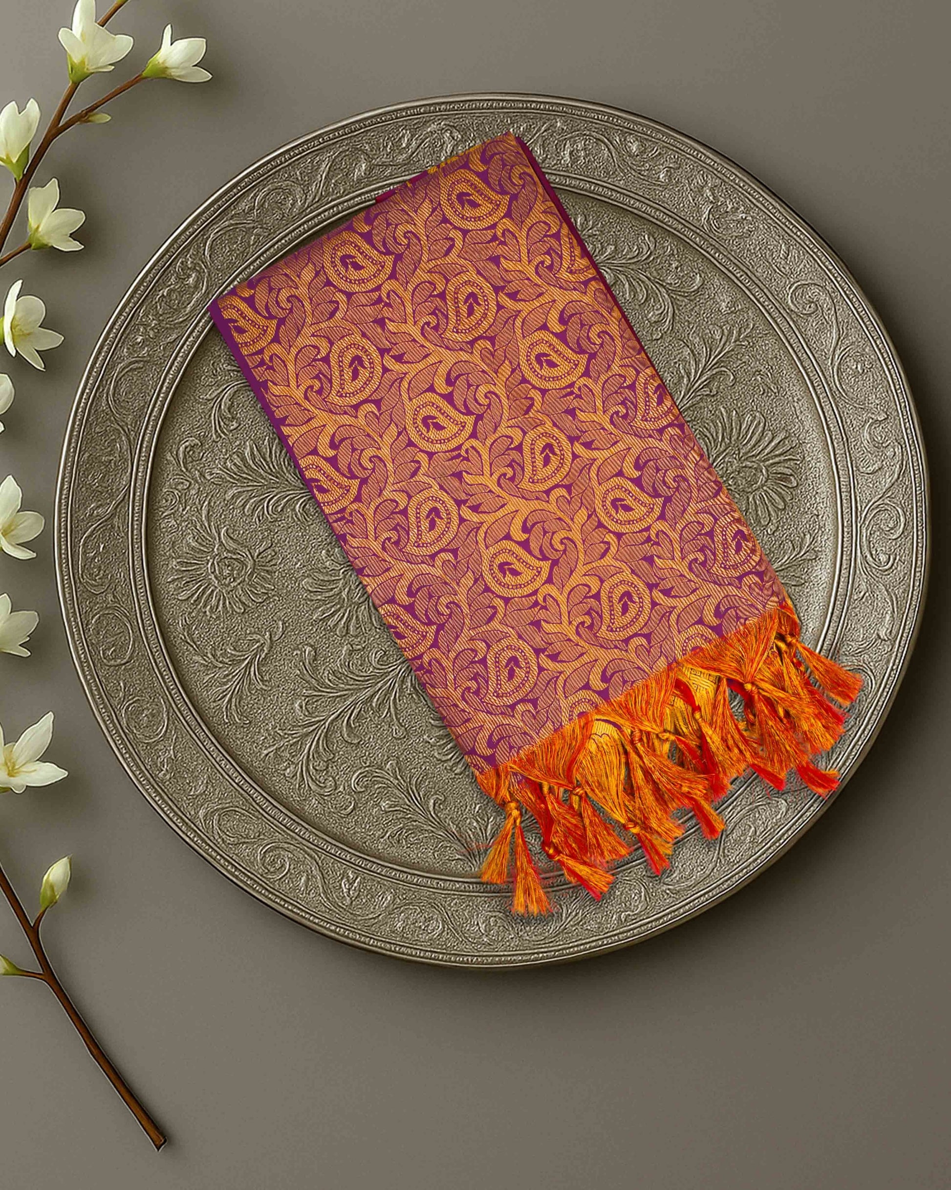 Ambika Stores premium purple and gold zari Ponnadai shawl with intricate paisley patterns and orange tassel ends.