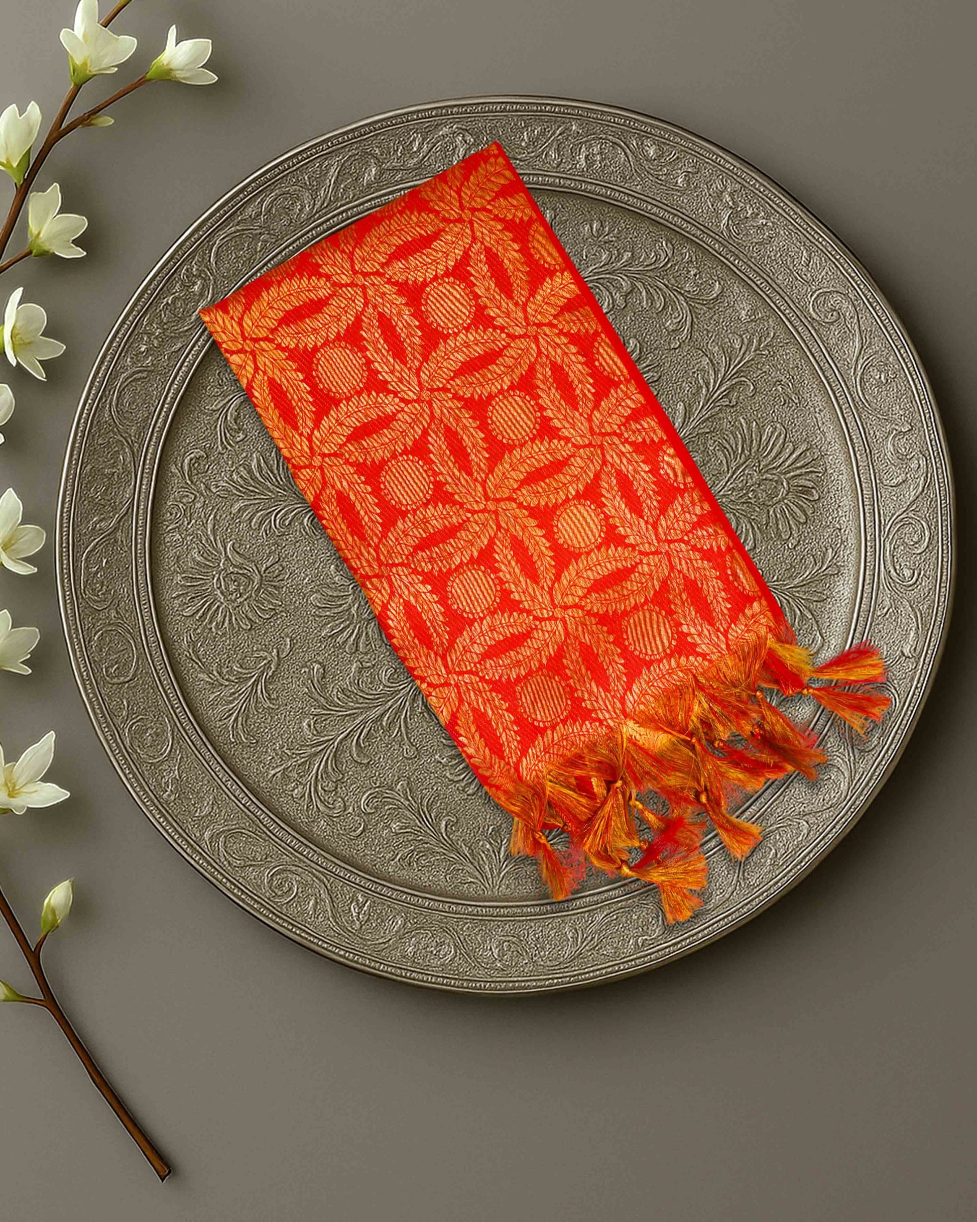 Ambika Stores premium red and gold zari Ponnadai shawl with intricate floral patterns and decorative tassels.