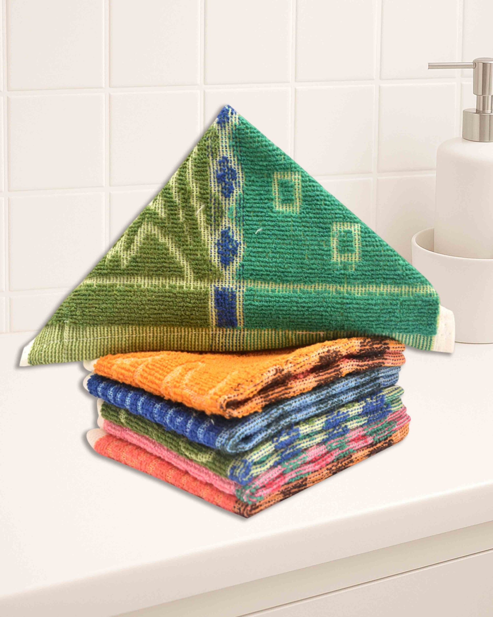 Ambika Stores cotton hand towel set featuring vibrant patterned washcloths in green, orange, blue, and pink.