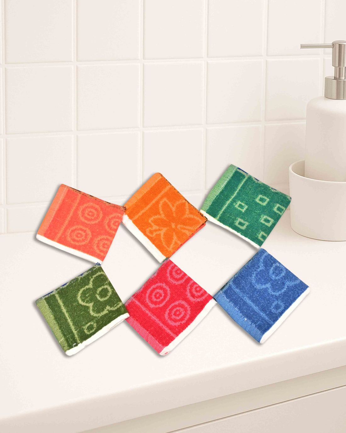 Ambika Stores cotton hand towel set featuring six colorful 10x10 inch washcloths with floral and geometric patterns.