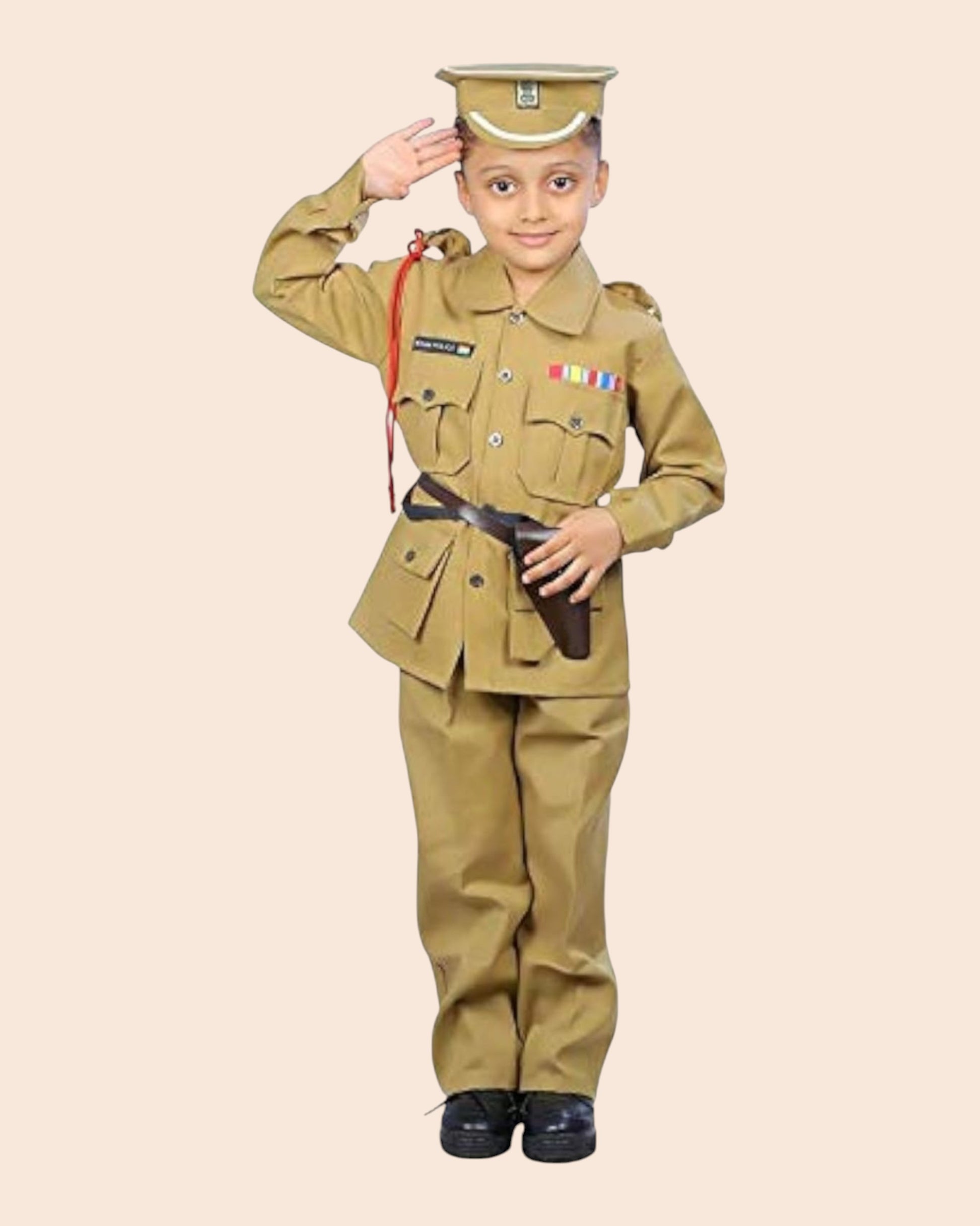 A young boy modeling a khaki military costume set, including a uniform jacket and trousers, a matching peaked cap, and a black belt, saluting against a solid beige background.