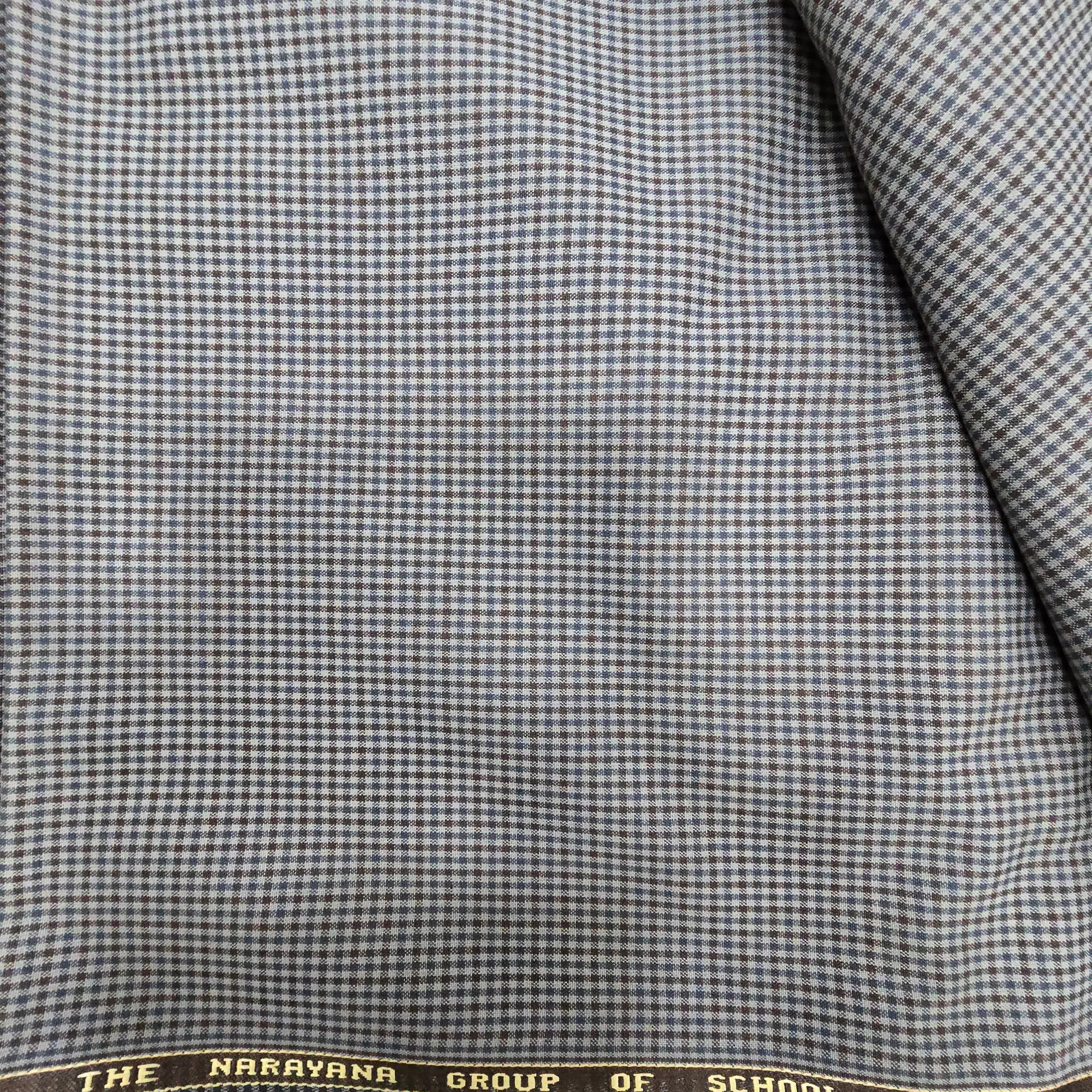 Ambika Stores blue and brown checked suiting fabric for Narayana school uniforms. Durable blend for blazers, trousers, skirts.