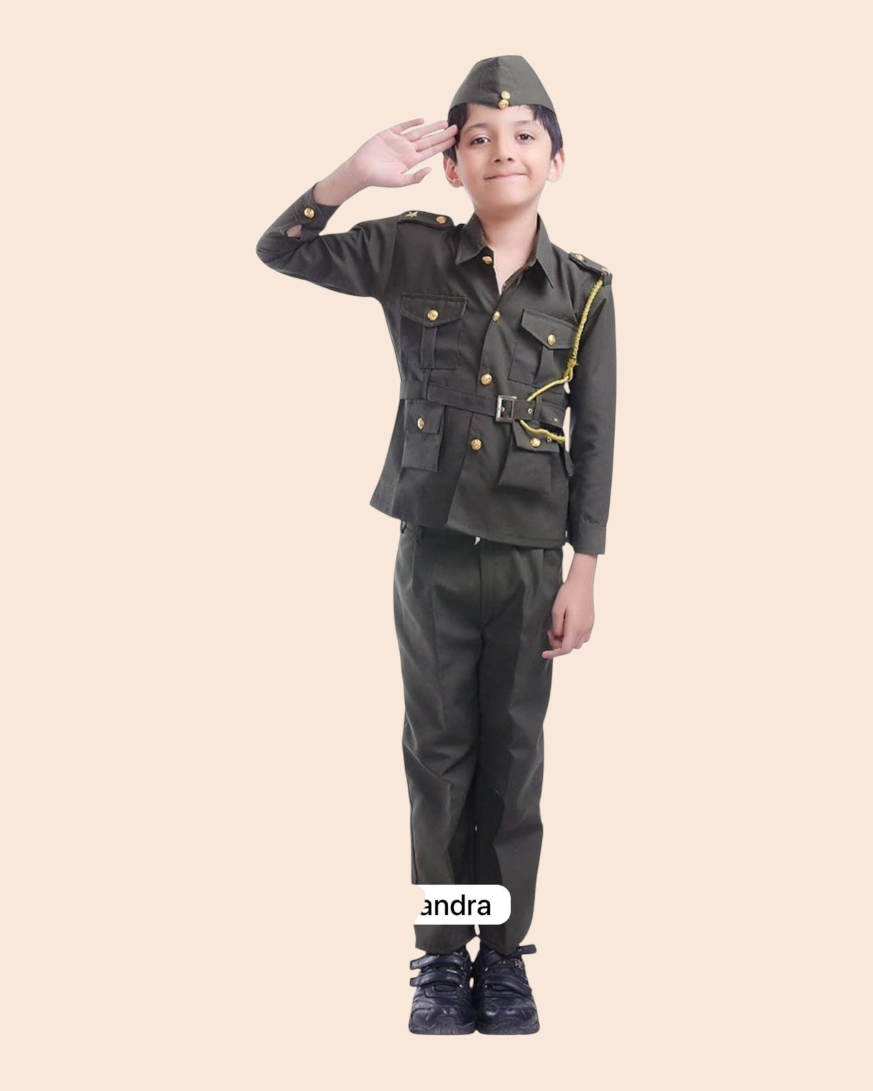 A child modeling a military-style costume set consisting of a dark olive green jacket with gold buttons and piping, matching dark green trousers, and a matching cap, set against a solid pale beige background.