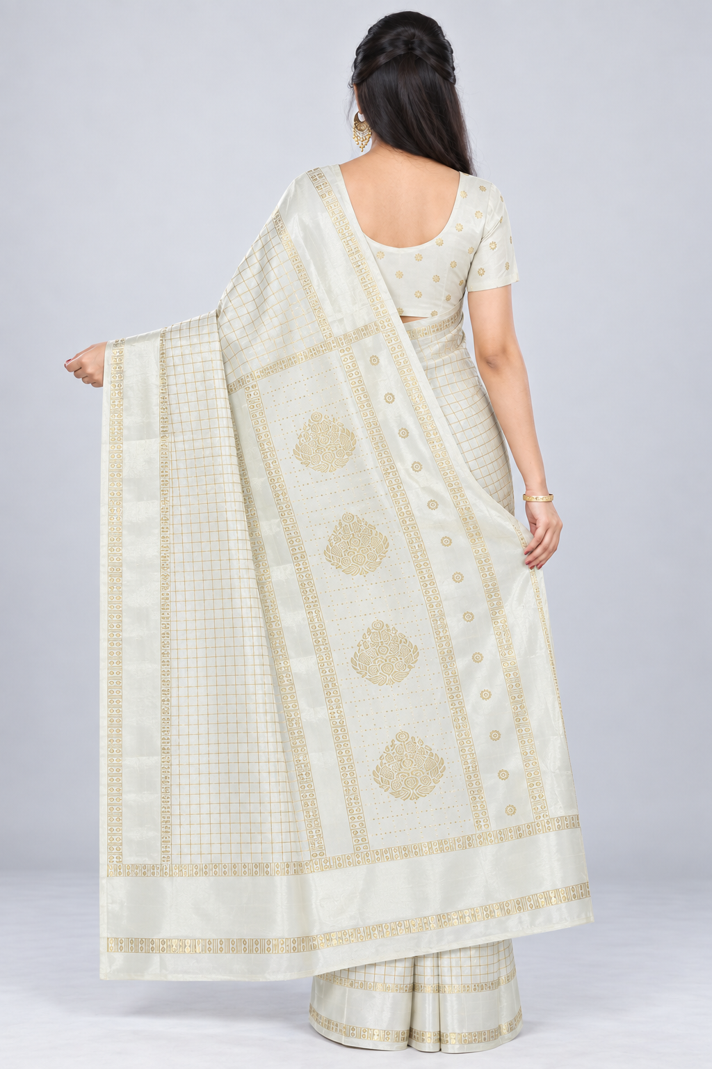 Back view of PARIS BEAUTY ivory saree showing the spread gold-tone patterned pallu and matching blouse styling.