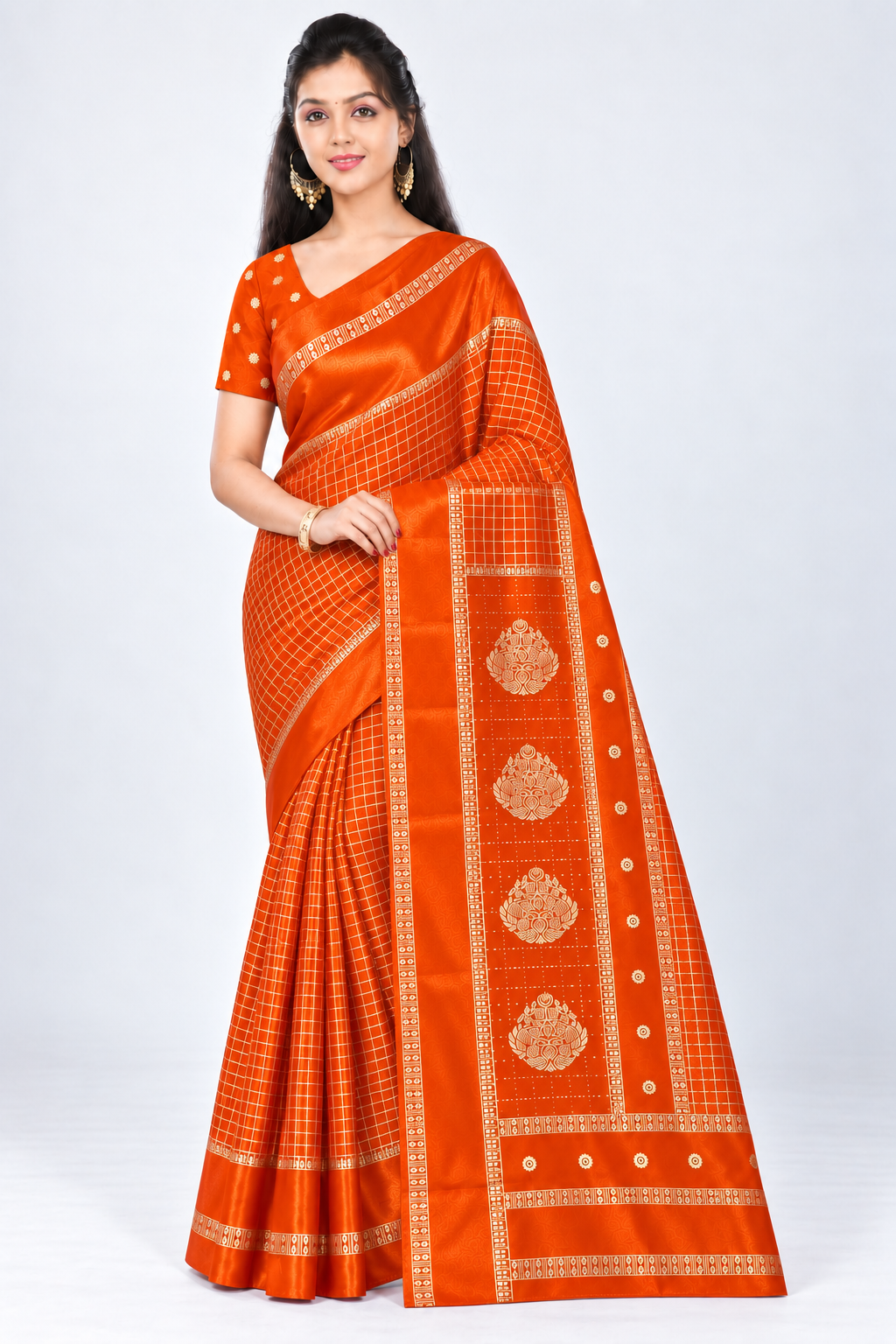 Three-quarter view of PARIS BEAUTY orange Turkey Silk saree with gold-tone checks, decorative border and ornamental pallu.