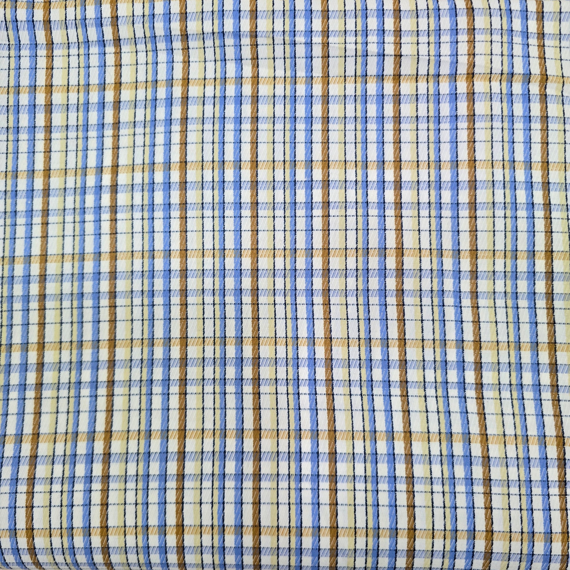 Close-up of plaid fabric with blue, brown, and beige colors.
